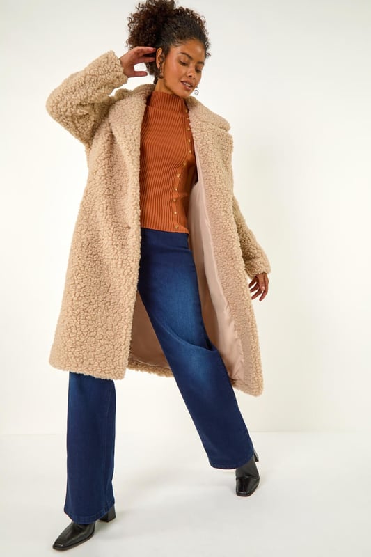 Dusk Borg Detail Longline Coat from Roman. Wrap up in style this Winter with this full-length Borg coat in classic biege. The soft Borg fabric provides ultimate warmth while the button detailing adds a touch of sophistication. Perfect for chilly days, this coat is ideal for layering over your favourite knitwear and jeans for a chic and cosy look that will keep you stylishly warm all season long!