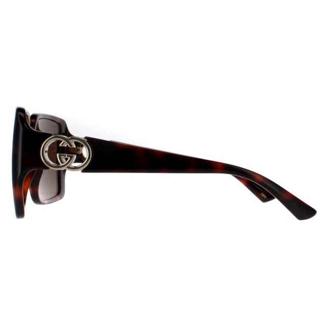 Gucci Square Womens Dark Havana with Gold Dark Brown GG1692S  Sunglasses feature a striking, oversized frame with a unique, softly contoured shape that enhances any look with a touch of glamour. Embellished with the iconic double-G logo on the temples, the GG1692S model proudly showcases the essence of Gucciâ€™s timeless style. The high quality lenses ensure exceptional UV protection, making them as practical as they are stylish. Available in a variety of refined colors, these sunglasses are the perfect choice for those who seek to combine bold elegance with modern fashion sensibilities.