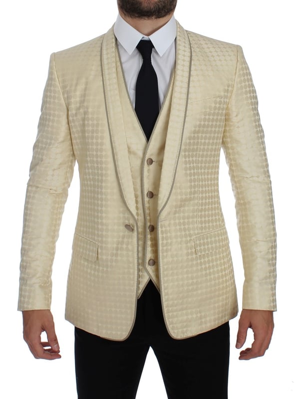 Brand: Dolce & Gabbana
  Style: 2 Piece Single breasted two button blazer and vest
  Fitting: Slim fit
  Color: Beige and gold
  Three outside pockets and two inside pockets
  One open vent in the back
  4 button closure vest with adjustable back strap
  Logo details
  Made in Italy
  Material: 58% Polyester 42% Silk
  Lining: 51% Acetate 49% Rayon
Material: 58% Polyester 42% Silk