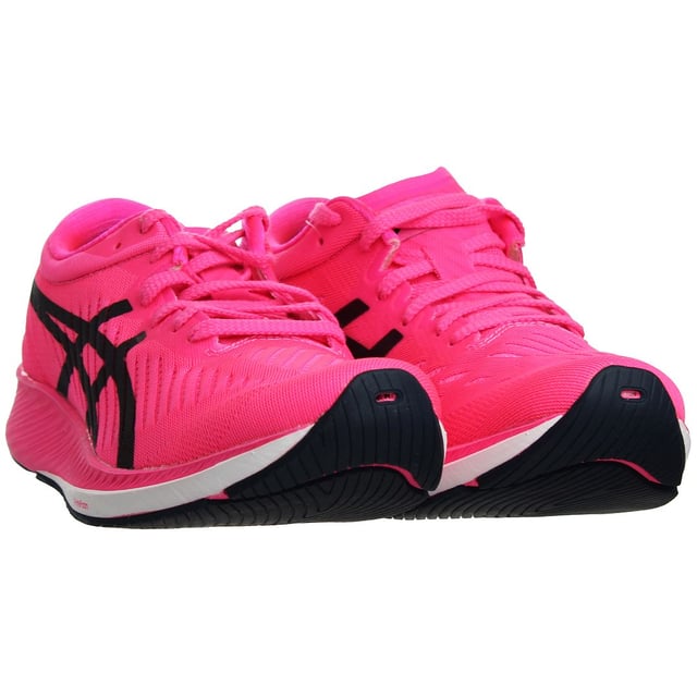 The Asics MetaRacer Women's Running Trainers are the pinnacle of performance footwear, meticulously engineered to elevate your running experience to new heights. Whether you're a competitive athlete or a dedicated enthusiast, these trainers are designed to help you achieve your personal best and dominate the race track or the road.

Key Features:

 Innovative Carbon Plate Technology:  The MetaRacer boasts a cutting-edge carbon plate embedded within the midsole. This plate delivers exceptional energy return and propels you forward with every stride. It effectively reduces energy loss and muscle fatigue, making these trainers ideal for long-distance runs and races.

 Lightweight and Responsive FlyteFoam:  Asics' FlyteFoam technology is incorporated into the midsole, providing a perfect balance of lightweight cushioning and responsiveness. This ensures a comfortable and efficient ride, helping you maintain your pace even during intense workouts.

 Enhanced Breathability:  The upper of the MetaRacer is constructed with a breathable mesh material that keeps your feet cool and well-ventilated, even on scorching summer runs. This design helps to prevent discomfort and blisters caused by excessive moisture and heat.

 Secure and Comfortable Fit:  These trainers feature a snug and supportive fit, thanks to the padded collar and traditional lacing system. The heel counter ensures stability, reducing the risk of injury during quick maneuvers or sprints.

 Exceptional Traction:  The outsole of the MetaRacer is equipped with a high-traction rubber compound that offers excellent grip on a variety of surfaces. Whether you're running on the track, road, or trails, you can trust these trainers to keep you stable and in control.

 Gender-Specific Design:  Asics has meticulously crafted the MetaRacer specifically for women's feet, taking into account the unique biomechanical needs and anatomy. This ensures a more comfortable and efficient running experience.

 Stylish and Sleek Design:  Beyond their outstanding performance, the MetaRacer trainers feature a modern and stylish design. You'll not only perform your best but also look your best while doing it.

 Versatile Performance:  These trainers are designed for a wide range of distances, from 5Ks to marathons. They excel in providing the support and energy return needed for both short, explosive sprints and long, steady runs.

 Reflective Details:  Safety is a top priority. The MetaRacer incorporates reflective elements to enhance your visibility during low-light conditions, ensuring you can run with confidence anytime, anywhere.

 Durability:  Asics has engineered these trainers to withstand the rigors of regular training and racing. The quality materials and construction ensure that your investment in the MetaRacer will last for many miles to come.

In summary, the Asics MetaRacer Women's Running Trainers are a perfect fusion of cutting-edge technology, comfort, and style. They're a must-have for any serious female runner looking to unlock her full potential and achieve race-day success. Whether you're aiming for a personal record or just want a comfortable and stylish pair of running shoes for your daily workouts, the MetaRacer has you covered. Elevate your running experience with the MetaRacer and leave the competition in the dust.