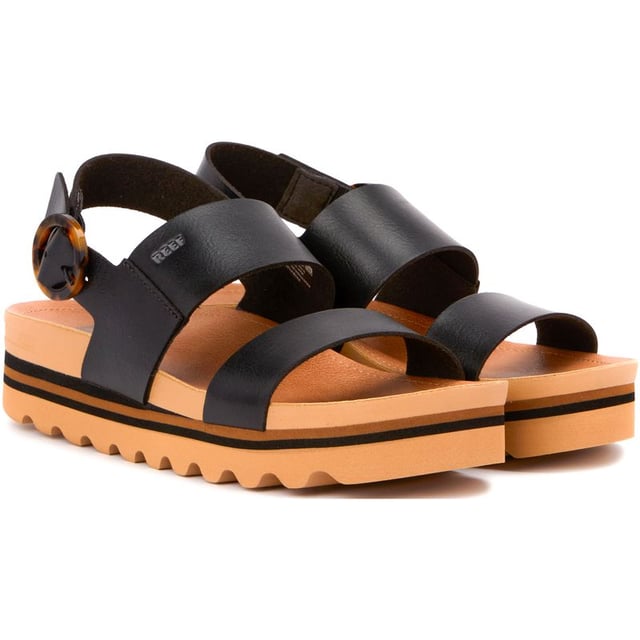 Experience Luxury In Summer Style With The Reef Cushion Vista Hi Buckle Platform Sandals. The Vegan Upper, Adjustable Back Strap And Ample Arch Support Give Your Feet A Comfy Ride. The Platform Sole And Heel Cup Offer Stability And Comfort. These Black Sandals Combine Fashion And Function. Feel Good And Look Fab With The Reef Cushion Vista Hi Buckle Sandals.