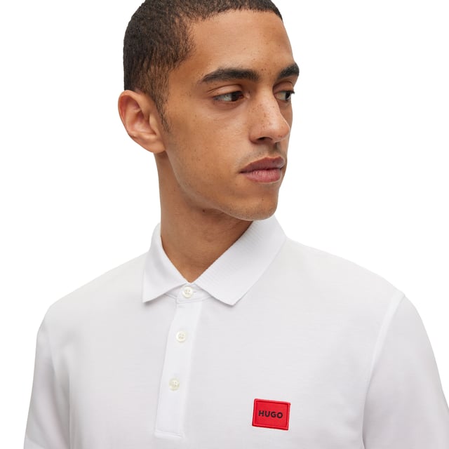Men's polo shirt from the HUGO brand. Plain-coloured pique polo with woven label on the left chest. Made of pure cotton.