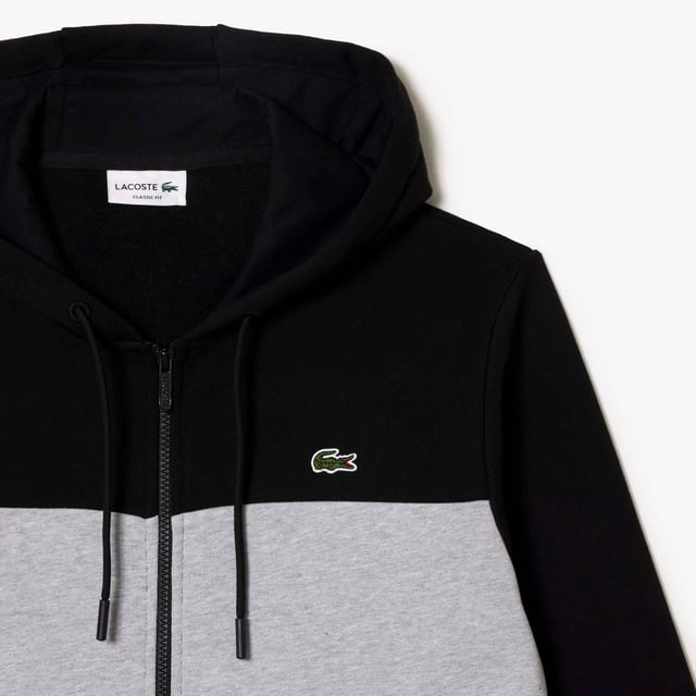 Men's Lacoste Zipped Colourblock Jogger Hoodie.- Unbrushed fleece.- Classic fit for natural ease.- Lined hood.- Branding on sleeve.- Crocodile on chest. Material: 100% Cotton. Ref: SH1416SNP.