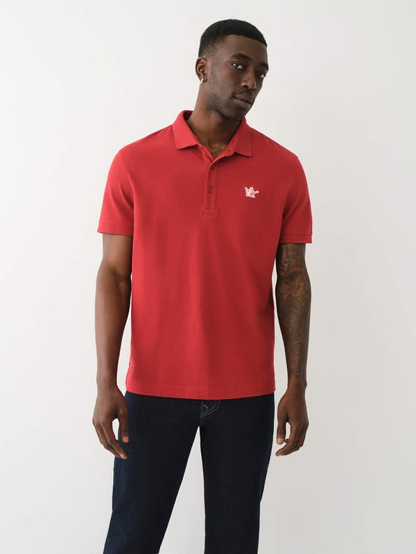 Pop that collar with the Buddha Patched Logo Polo Shirt. Crafted from soft cotton, this men’s polo features a basic collar. half-button placket, and short sleeves. Finished with a relaxed fit, ribbed trim, and a chest Buddha patch.
