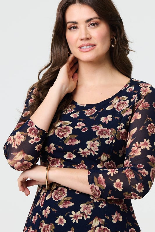 Navy Floral Sparkle Mesh Knee Length Dress You can never have too many floral dresses! This one has a feminine lace layer design, along with a flattering skater fit. It also features 3/4 sleeves, a scoop neck and a knee length hem. Wear with heels for a special occasion such as a wedding or a party.