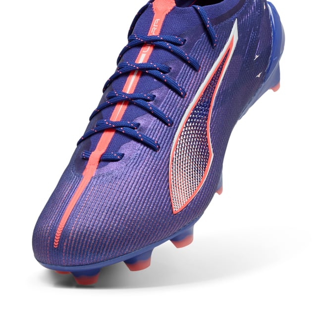 PRODUCT STORY: Fasten your seatb. . .we mean laces. With the ULTRA 5 football boot, you get the speed and sensation of a finely tuned machine at your feet. Built on engineering insights from PUMA Motorsport, the brand-new SPEEDSYSTEM outsole and FastTrax stud design are precision-engineered to take you from kick-off to back-of-the-net faster than you can say: lights out.  FEATURES & BENEFITS: ACCELERATION: The SPEEDSYSTEM outsole design combines a high-performance fibre base material with a revolutionary stud system, maximising energy return for faster acceleration; TRACTION: FastTrax stud design using insights from academic research and traction studies to provide more traction while accelerating, cutting and breaking; STABILITY: PWRTAPE SQD support frame stabilises the foot inside the boot without hindering agility or freedom of movement; The upper of this shoe is made with at least 50% recycled materials. DETAILS: Lightweight mesh upper; Lightweight removable sockliner with NanoGrip technology keeps the foot from slipping inside the boot; OrthoLite® heel cushioning for better lockdown; SPEEDSYSTEM outsole; Regular to narrow fit; Low-cut slip-on construction; FG: Suitable for use on firm ground.