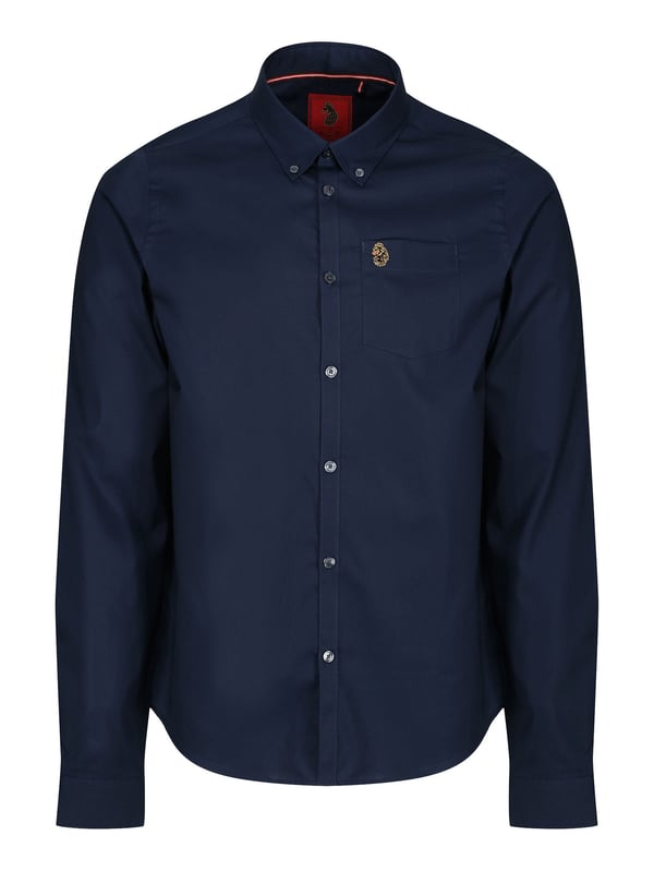 This classic LUKE long sleeved shirt is an essential item for your wardrobe, classically styled with a buttoned-down collar and a simple chest patch pocket. It is detailed with imitation river shell plastic buttons on the central front placket, running from hem to collar and is completed with the brand's iconic lion head embroidery on the left chest. Tailored fit. Iconic LUKE BLACK, GOLD, RED lion head embroidery. Iconic LUKE tri-colour trim tape. Left chest pocket detail-Imitation river shell plastic buttons. Central front placket. Button down collar detail at front and central at back. Back yoke detail and external back box pleat. Long sleeve with buttoned cuff.