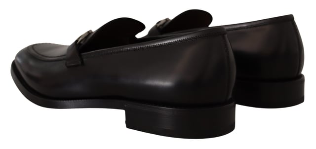 Brand new with tags and dust bag
  100% authentic Salvatore Ferragamo mens shoes
  Model: Lewis
  Color: Black
  Material: 100% Calf Leather
  Formal version of the gentlemens loafer
  Calf leather tumbled and hand buffed for depth of color
  Gancio bit in cool palladium finish
  Open grooves reveal stitching on leather sole
  Made according to Originali construction method
  Made in Italy
Material: Calf Leather