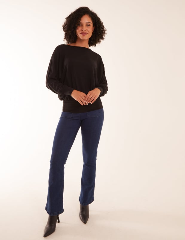 Doesn't matter if you are going to work or a late-night cocktail with friends, you will not go wrong with the batwing top. You can match this top with wide leg jeans and short heel boots.