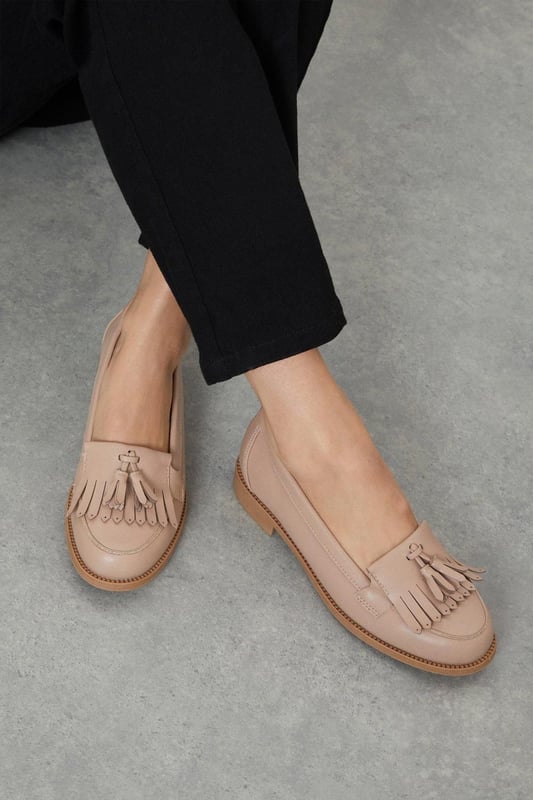 Faux leather loafers with a wide fit for added comfort
Sleek and polished design with a fringed tassel detail
Flat sole offers a versatile wear from day to night
Slip-on style for easy on and off
Synthetic lining and outsole for durability

Exude effortless sophistication with these Wide Fit Leigh Fringe Loafers from Dorothy Perkins. The faux leather construction lends a luxurious touch, while the fringed tassel detail adds a playful twist to the classic silhouette. Designed with a wide fit, these loafers offer ample room for all-day comfort. Pair them with tailored trousers for a polished office look or team them with a flowy dress for a chic weekend ensemble. Their flat sole ensures versatility, allowing you to transition seamlessly from desk to dinner.
