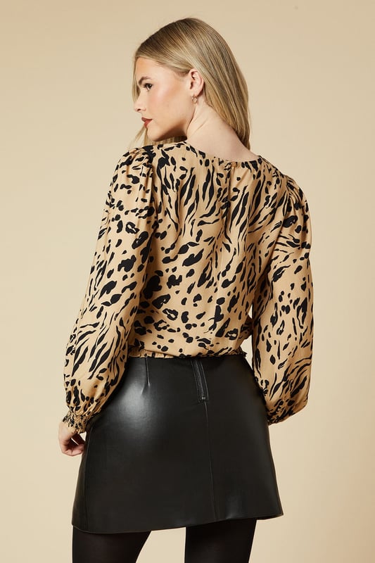 Striking animal print design for a bold, eye-catching look
        Relaxed fit with shirred hem for a flattering silhouette
        Round neckline for a classic, versatile style
        Long, voluminous sleeves add a touch of drama
        Lightweight viscose fabric ensures all-day comfort
    
    Make a statement with this captivating animal print top from Dorothy Perkins. The relaxed fit and shirred hem create a flattering shape that's perfect for various body types, while the round neckline keeps the look timeless and adaptable. Style this versatile piece for a range of casual occasions - pair it with your favourite jeans and trainers for a laid-back weekend brunch with friends, or dress it up with a sleek midi skirt and ankle boots for a family gathering. The lightweight viscose fabric makes it ideal for layering under a cardigan or jacket as the weather cools. Whether you're heading to a baby shower or meeting up for coffee, this top will ensure you look effortlessly chic while feeling comfortable throughout the day.