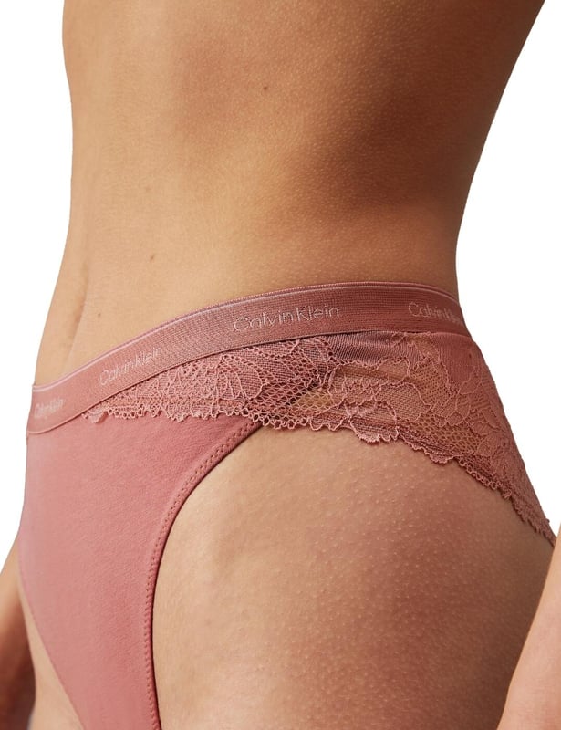 Calvin Klein Modern Lace Tanga Treat yourself to some new designer pieces such as the Calvin Klein Modern Lace tanga brief. With its high waistline and leg rise, this brief offers just the right amount of coverage and shows off your beautiful curves. The lace sides and back add a touch of femininity and elegance, making you feel effortlessly alluring. But don't let the delicate lace fool you, the smooth opaque front provides ultimate comfort and ensures a seamless look under any outfit. As a signature of Calvin Klein, the waistband features the iconic logo, elevating this tanga brief to be more than just a piece of lingerie, but a fashion statement. And with cheeky rear coverage, you'll feel just the right amount of playful and flirty. Complete the set with matching coordinates, available with the same alluring lace and signature waistband today!
Tanga brief
High-rise waist
High leg rise
Lace sides and back
Smooth opaque front
Calvin Klein signature waistband
Cheeky rear coverage
Matching coordinates available
Country of origin: Indonesia
Composition: 80% Nylon | 20% Elastane
Listed in UK sizes
Tanga Brief