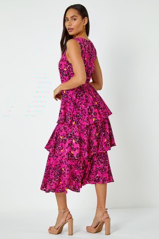 Abstract Animal Print Tiered Midi Dress from Roman. Frills galore! These trending silhouettes with multi-tiered skirts are a new season must-have! Adorned in a unique animal style print, the stylish v-neck and button back create an easy wear and will elevate any look you have planned this summer. Wear this beauty to your next spring occasion with contrast heels and matching clutch to make a style statement!