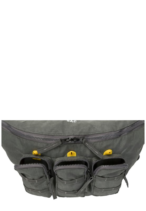 The ultimate carry companion, perfect for every day wear. Featuring a full-length zip top opening and 3 large side pockets, the Haring Triple Holdall is spacious enough for any short or long trip away. Features a detatchable shoulder strap. Features: , Water Resistant, 15 inch padded laptop sleeve - Fits Apple MacBook Pro 16 inch, Grab handle carry straps, Removable shoulder strap allowing crossbody styling, Zip top opening to main compartment, Triple front zip pocket with webbing loops Single zip pocket for smaller valuables, Internal zip pocket, 2 Internal mobile phone slip pockets - Fits normal and plus size smart phones, 3 Internal pen slip pockets, External rear zip pocket Style Ref: 52004 GREY
