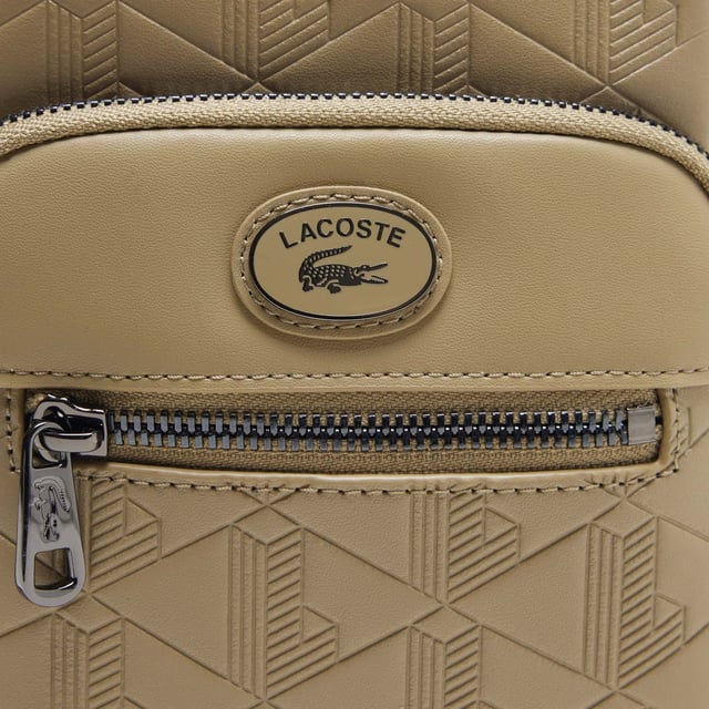 Monogram Print Small Crossover Bag.- Dimensions: L5.1 x L7.2 x D2.7 in.- L13 x H18.5 x D7 cm.- Exterior in Split Calfskin Leather.- Adjustable strap: 75cm - 140cm - 29.5 - 55 in.- 2 zipped outside pockets, 1 mesh inside pocket.- Enamel plaque with crocodile logo. Material: 100% Split Calfskin Leather. Ref: NH4399MRC87.