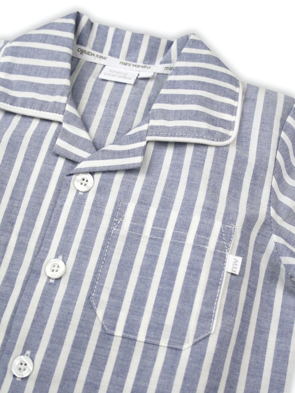 Blue and White Stripe Traditional Shortie Pyjamas.

Our classic short sleeve crisp summer cotton boys pyjamas in a blue and white stripe creates a traditional look that’s perfect for lounging or sleeping. Made from super-soft 100% crisp cotton. The set is trimmed with white cotton piping. The top has an open collar and revere, single square pocket with MV tab and fastens with Mini Vanilla Engraved buttons. The crisp cotton comfy shorts have a fully soft elasticated waist for extra comfort. 

Sold as a Pyjama set.
Fabric 100% cotton - crisp summer weight.
Fire Warning : KEEP AWAY FROM FIRE AND FLAMES.
Wash Care Instructions : Machine wash inside out, do not soak, wash dark                    colours separately, do not iron trims. Save energy and wash at 30 degrees.
Do not tumble dry