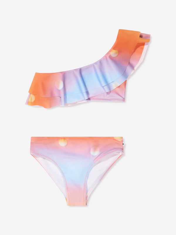 Introducing the Girls Sun Print Nikkie Asymmetrical Bikini In Orange by Molo, an essential add-on to your little girl's summer wardrobe! Here are its standout features:  Boutique Design: Flaunts an asymmetrical cut, lending a trendy, high-fashion look. Vivid Sun Print: The vibrant sun print in orange is playful and attractive, ensuring your little one shines brighter than the summer sun. Premium Quality: Crafted from superior fabric, this bikini promises utmost comfort and an excellent fit. Perfect for Summer: Its radiant colour and quirky design make it an ideal piece for beach days or pool parties.Add this Girls Sun Print Nikkie Asymmetrical Bikini In Orange from Molo to your cart and let your girl embrace summer in style!