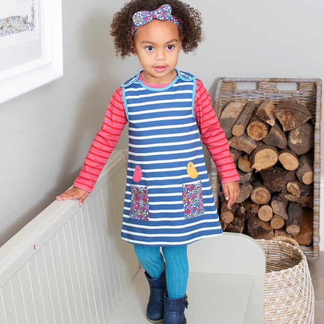 New! A fresh style with classic beauty, our new pinafore will look fabulous with so many of our tops and tights this season. In our organic yarn dyed stripe sweat fabric featuring our cute berry ditsy print pockets, the two little contrast appliqué birdies perched on top are sure to make the best of friends with your very own little fashionista. Finish the look with our berry ditsy bowband.