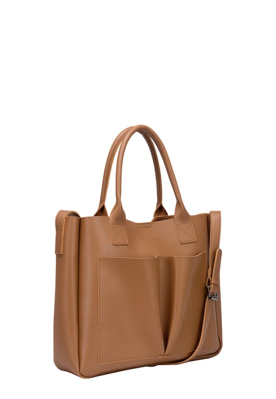 Be anything but basic with this classic wardrobe staple. The Megan XL Tote is the perfect accessory for making a statement and is highly functional too. Inside is a spacious compartment, big enough to carry the days essentials. You can also find a pouch which can be removed, ideal for storing items you want to keep extra secure, or use it as a mobile makeup bag! You have a choice of styling with the tote grab handles and the adjustable shoulder strap, so you can change your look depending on your chosen style! Features: , Lightly textured PU exterior, Claudia Canova debossed logo, Magnetic clasp fastening, Two exterior slip pockets, 2 x tote grab handles, Adjustable shoulder strap, Interior pouch which can be removed using the snap button clasps, Pouch measurement: W 304 x H 203 x D 63 mm, Zip top fastening on interior pouch Style Ref: 84607 TAN