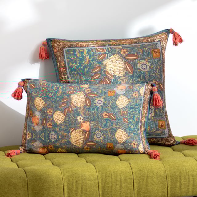 Inspired by arts and crafts, the Bolais cushion fuses mesmeric colour combinations together to create a busy palette of tones and floral patterns which are all printed on incredibly soft cotton and set against a deep toned teal background. Surrounded by a contrasting tassel on each corner for a bit of added style, this cushion brings a splash of colour to many contemporary interiors.