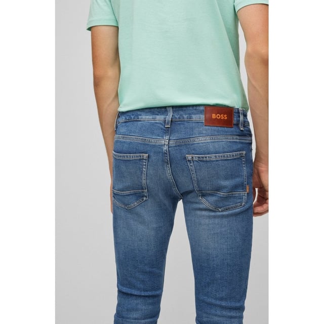 Five-pocket jeans by BOSS Menswear with signature trims and an authentic lived-in look. Delivered in a dark-blue tone for year-round styling, these jeans are cut to a narrow fit with a regular rise in comfort-stretch denim for lasting shape recovery. For our RESPONSIBLE products, we always use at least 60% more sustainable raw materials. This garment is made from at least 60% certified organic cotton. Organic cotton is only grown with naturally occurring substances and no genetically modified seeds. Organic farming encourages the use of natural measures, such as crop rotation and composting, to control pests and diseases rather than relying on chemicals.
Slim fitRegular riseButton and zip closurePockets bottom front: Side pocketsSlim legPockets bottom back: Patch pocketStandard lengthFit foot width: 36,0 cm
90% Cotton, 8% Polyester (recycled) , 2% Elastane
50471138