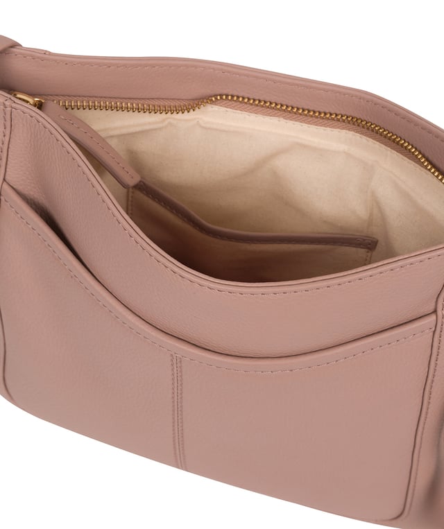 The 'Lewes' cross body bag from Pure Luxuries London, is crafted from naturally milled leather with a beautifully distinct fine-grain feel. A zip-over top secures a gorgeous, 100% natural cotton-lined interior with two slip pockets. On-the-go storage comes in the form of an exterior zipped pocket and two slip pockets, complemented by an adjustable and matching leather shoulder strap. Furnished with gold coloured metal fittings and the elegant Pure Luxuries London charm and logo plate.