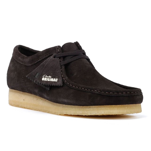 The iconic Clarks Wallabee shoe in boot style. The moccasin-inspired, structured silhouette offers clean and simple lines. Crafted from suede, the Wallabee boots features a lace up fastening and distinctive crepe sole.