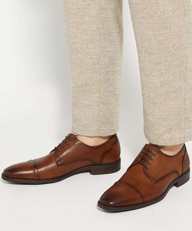 Dune Mens Suffix - Leather Toe Cap Lace Up Derby Important date in the diary? Our timeless lace-up Derby has been designed for those who need to maintain a polished appearance without compromising on comfort. Crafted from smooth, burnished premium leather and boasting a low-block heel and toe cap, this versatile design is guaranteed to enhance every smart outfit. Thanks to the soft cushioning and ergonomic design that supports your feet all-day- long, this hybrid profile will allow you to transition seamlessly from meetings to social events. The flexibility in the sole allows for natural foot movement, reducing strain during long hours of we