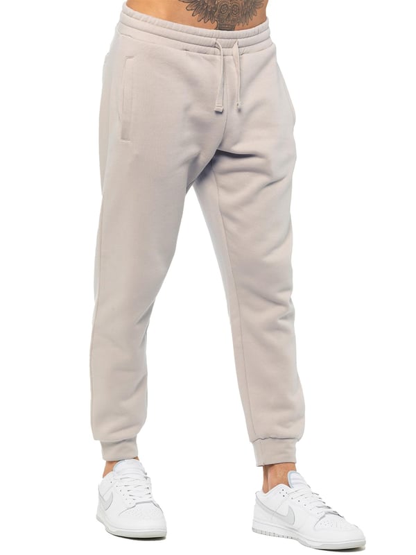 Experience ultimate comfort in our Enzo Mens Regular Fit Joggers. Made with a soft brushed back inner fleece lining, these joggers are perfect for casual wear. The cuffed leg design and elasticated waist with drawstrings provide the perfect fit. With 2 side slash pockets, you can easily carry your essentials.