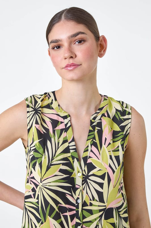 Sleeveless Leaf Print Blouse from Roman. Have fun with tropicals this season with our vibrant leaf print blouse. Cut from a smooth woven fabric, this top features a feminine notch neckline and is designed in a Summer-ready sleeveless style. Adorned in a bold palm leaf print, this piece has sweet button detail at the front for the perfect finishing touch. Pair with cropped trousers and sandals for a day of sightseeing in the city then simply add a lightweight denim jacket for dinner!