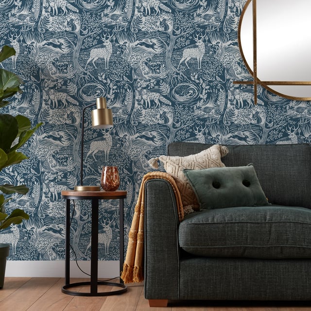 Invite nature into your home with the Winter Wood wallpaper featuring a stunning woodblock inspired print with plenty of woodland animals and trees. The elegant and graceful highland stag is complimented by hares, foxes, and owls in gorgeous rich blue palette, this design will add a focal point to your décor. This wallpaper is a paste the wall application; simply paste the wall, hang your paper, and leave to dry. Each roll is 10m long and 52cm wide. Pattern repeat: 53cm Straight Match. Our Winter Wood wallpaper can be used to paper the whole room or to create an eye-catching feature wall. This wallpaper is also wipeable so that any light marks can be dabbed away.