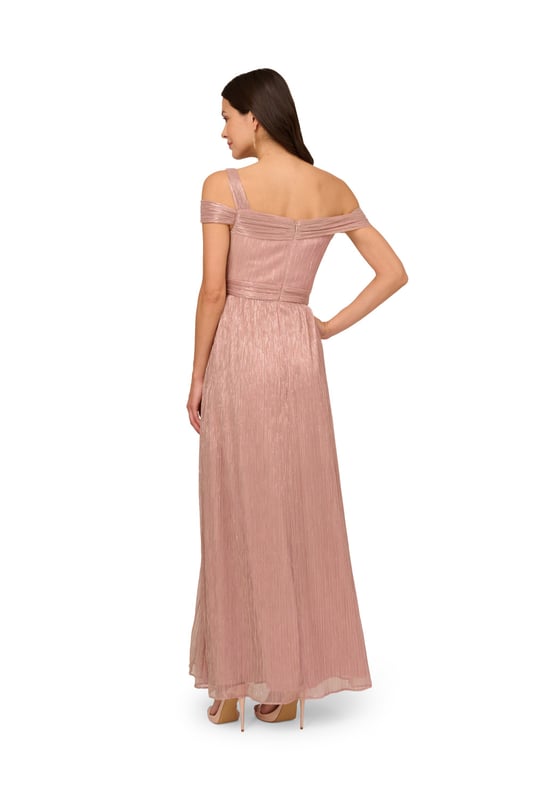 Take the spotlight in this dreamy metallic gown. This formal dress features a shirred bodice with an asymmetrical neckline, draped shoulder sleeves and a single strap at one side, and a side slit cut out of the soft skirt. Crafted from crinkle metallic fabric, this evening gown is fully lined. A zipper closure at the centre back completes the design. Nude heels and a beaded clutch are the perfect accessories to complete this dress for formal and black-tie events.