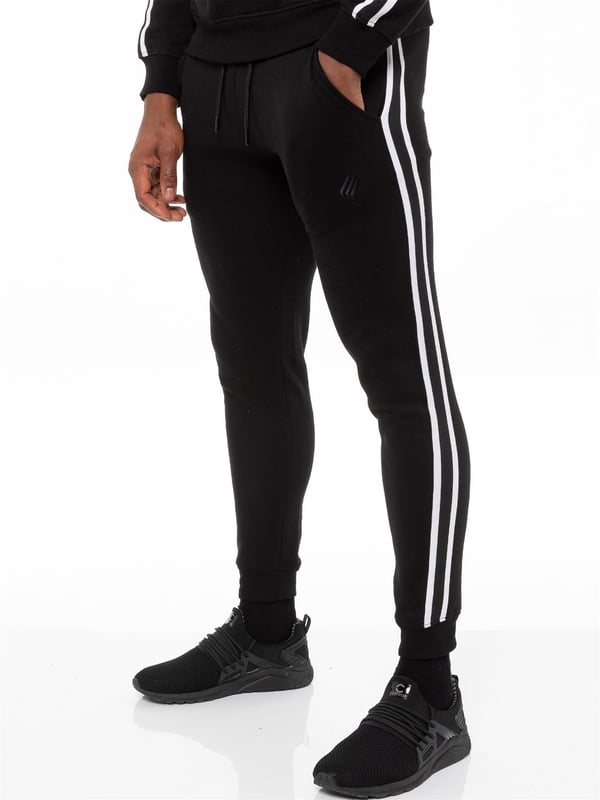 Enzo Mens Tape Hoodie Full Zip Tracksuit. Zip Through Hooded Top. Enzo Embroidery Logo on Chest and Contrast Stripe Design on Sleeves. Hoodie with Drawstring. Ribbed Waist and Cuffs. Kangaroo Pockets. Enzo Mens Casual Designer Striped Tracksuit Joggers. Featuring Classic Contrast Stripes to Sides. 2 Side Pockets. Cotton Blend for Superior Comfort. Adjustable Waist with Drawstrings. Athleisure Perfect for All Gym wear