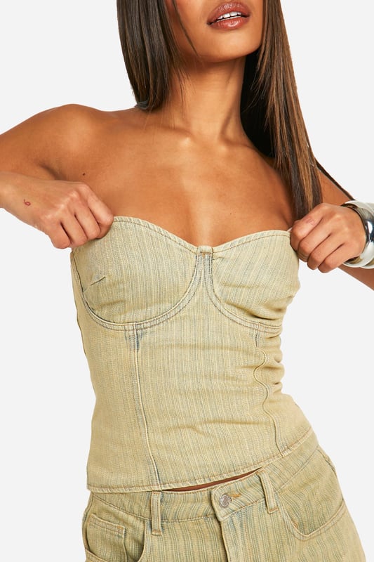 Strapless denim corset top with structured bustier design
        Flattering sweetheart neckline for a feminine silhouette
        Vertical seam detailing for a figure-enhancing effect
        Versatile toned denim fabric for day-to-night styling
        Pairs perfectly with matching wide-leg trousers for a coordinated look
    
    Make a bold statement with this eye-catching denim corset top from Boohoo. The structured bustier design and sweetheart neckline create a flattering silhouette that's sure to turn heads. Perfect for a night out on the town, this versatile piece can be dressed up or down to suit any occasion. Pair it with the matching wide-leg trousers and an oversized blazer for a chic, coordinated ensemble that's ideal for drinks with friends or dancing the night away. For a more casual look, team it with high-waisted jeans and trainers. The toned denim fabric adds a contemporary twist to the classic corset style, making it a must-have addition to your wardrobe. Whether you're hitting the club or meeting for cocktails, this corset top will ensure you stand out from the crowd.