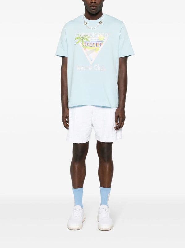 Casablanca's graphics often depict a fantastical world of sporty utopian scenes. The illustrative print on this organic cotton T-shirt portrays a Mexican-inspired landscape with a tennis court in the middle.