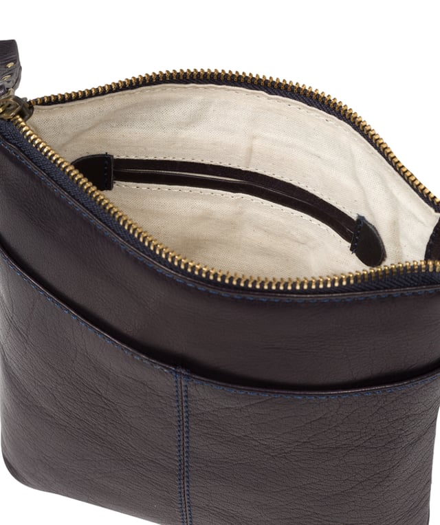 The 'Elf' cross body bag from Conkca London is handcrafted from multi-toned leather for a beautiful finish. A zip-over top opens to reveal a spacious compartment with two slip pockets, lined with natural and untreated 100% cotton. Features two zipped pockets on the front of the bag and a slip pocket on the rear. Comes with an adjustable leather strap with a maximum drop length of 70cm. Adorned with the inimitable Conkca squirrel charm and Conkca logos.