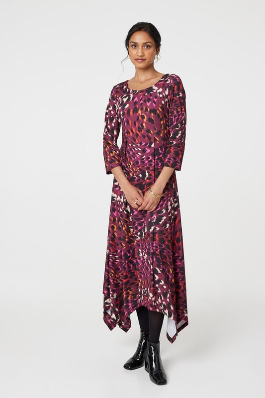 Add a vibrant animal print to your new season closet with this anima print midi dress. With a round neck, 3/4 sleeves, a hanky hem and a midi skirt. Style with strappy hees for a special event or pair with tights and block heeled boots to beat the chill.