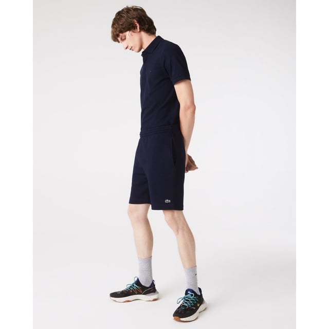 PRODUCT REF. GH9627-00 Efficient. Durable. Comfortable. An iconic, performance-enhancing essential that's comfortable enough to relax in. Regular fit, straight cut: Unrestricted freedom of movement. Drawstring waist: An adjustable waistband for optimum comfort. Back pocket with piping: Practical and functional. Embroidered crocodile on the front: Lacoste-typical performance. Brushed organic cotton fleece: Long-lasting comfort during sports. Main material: cotton (84%), polyester (16%) / pocket lining: cotton (100%)