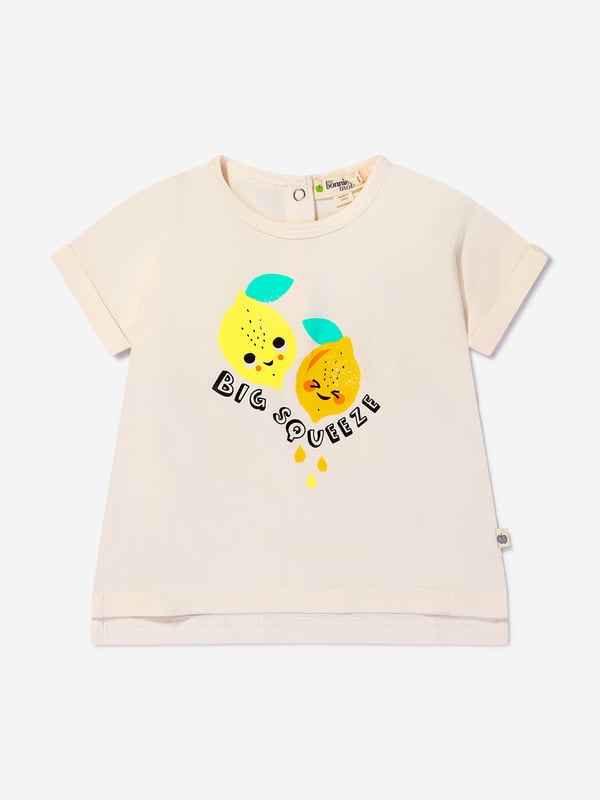 Introducing our Girls Organic Cotton Cherry Print T-Shirt from The Bonnie Mob in Pink, the perfect addition to your little girl's wardrobe. Made with love and care, this t-shirt is crafted from organic cotton, ensuring it is soft, comfortable, and gentle on her skin. Key Features: Made In Italy: This t-shirt is proudly made in Italy, guaranteeing the highest quality and attention to detail. Organic Cotton: We believe in sustainable fashion, which is why this t-shirt is made from organic cotton, reducing environmental impact. Cherry Print: The adorable cherry print adds a playful and cute touch to this t-shirt, perfect for your little girl. Flared Hem: Designed with a flared hem, this t-shirt offers a stylish and modern twist to a classic design. Long Waistband: The long waistband adds a touch of elegance and sophistication to this t-shirt. 'B' Motif: Featuring a golden 'B' motif, this t-shirt showcases The Bonnie Mob's signature logo, adding a touch of luxury to your little girl's outfit.Get ready to dress your little girl in style and comfort with our Girls Organic Cotton Cherry Print T-Shirt from The Bonnie Mob.