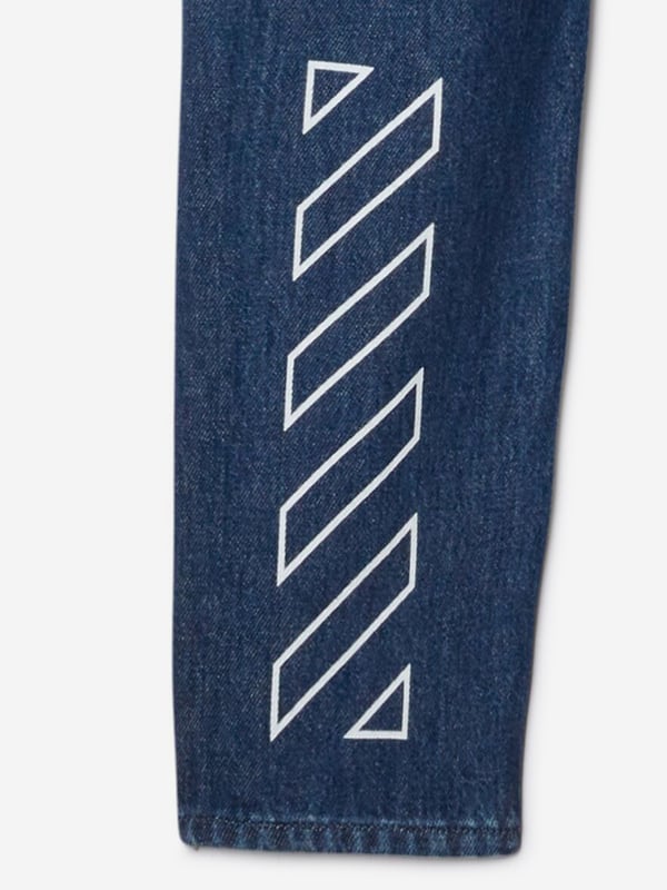 Introducing the Boys Bookish Patch Regular Jeans in Blue by Off White, a stellar addition for the discerning young fashion enthusiast's AW2024 wardrobe. Impeccably crafted, these jeans blend classic charm with contemporary flair. Key features include: Distinctive Bookish Patch: A unique, intellectual-themed patch adds an element of whimsy and sophistication. Premium Denim Fabric: Constructed from high-quality denim ensuring durability comfort. Versatile Blue Hue: Ideal for coordinating with a variety of tops and shoes.Elevate your boy's style with these must-have designer jeans. Perfect for school events or weekend outings!