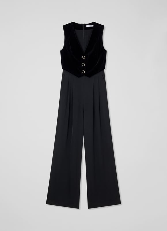 Be the center of attention with the Carine waistcoat culotte jumpsuit, ideal for evening events. In sleek black, this cotton blend jumpsuit boasts a v-neck, sleeveless design, mixed media details, and convenient pockets with a back zip. Combine it with statement heels and a clutch for an effortlessly stylish appearance.
