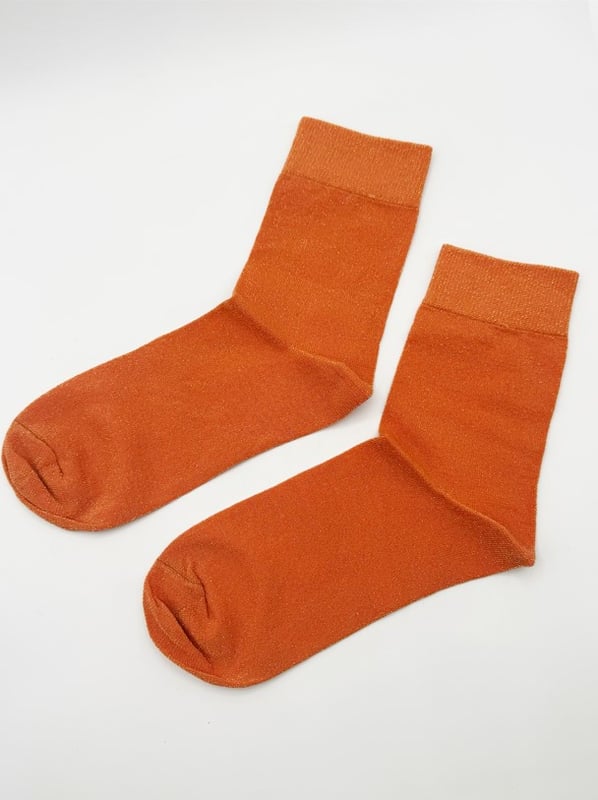 Get into the spirit of the season with this fun and vibrant glitter sock set by SVNX. Featuring two pairs in bold orange and green, they're perfect for adding a pop of sparkle to any outfit. Treat yourself or surprise someone special with a gift that combines style and festive flair! Knitted Glitter Socks Set. One size. 2 pairs. Gift Box. Cotton/Polyamide/Elastane. Wash at 40. Made in China
