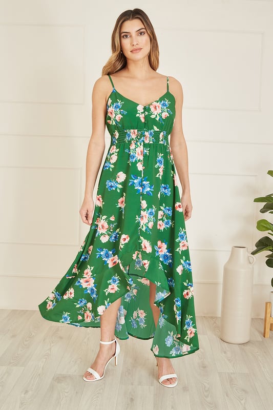 Spring in to summer in this gorgeous strappy midi dress from Mela. In an all over in house design floral print, with a ruched waistline, button details and that stunning flowy dip hem. Perfect for strolls on a beachfront, or those high summer wedding invites!