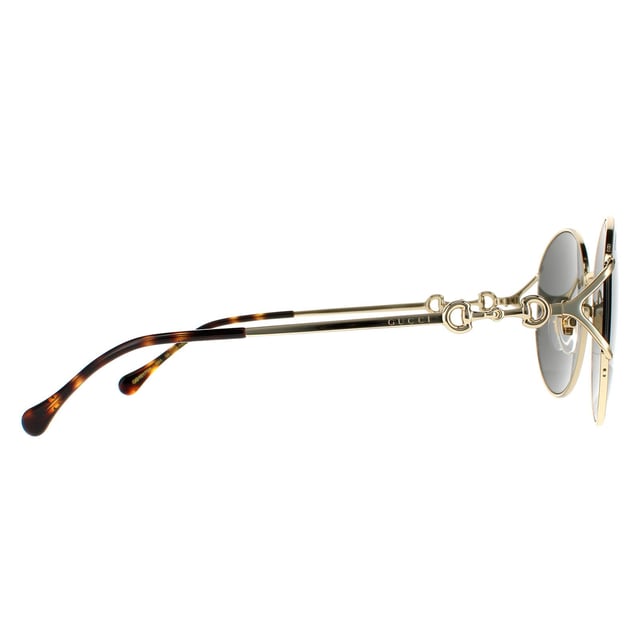 Gucci zonnebrillen GG1017SK 001 Gold Gray zijn een ongelooflijk glamoureus randloos ronde frame. De verstelbare neuskussens en plastic tempeltips zorgen voor een comfortabele de hele dag fit. De tempels geven het Gucci -logo voor merkherkenning