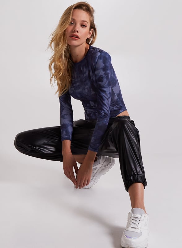 Nail the major trend this season with this bodysuit. Featuring a stonewash print with long sleeves and shoulder pads.