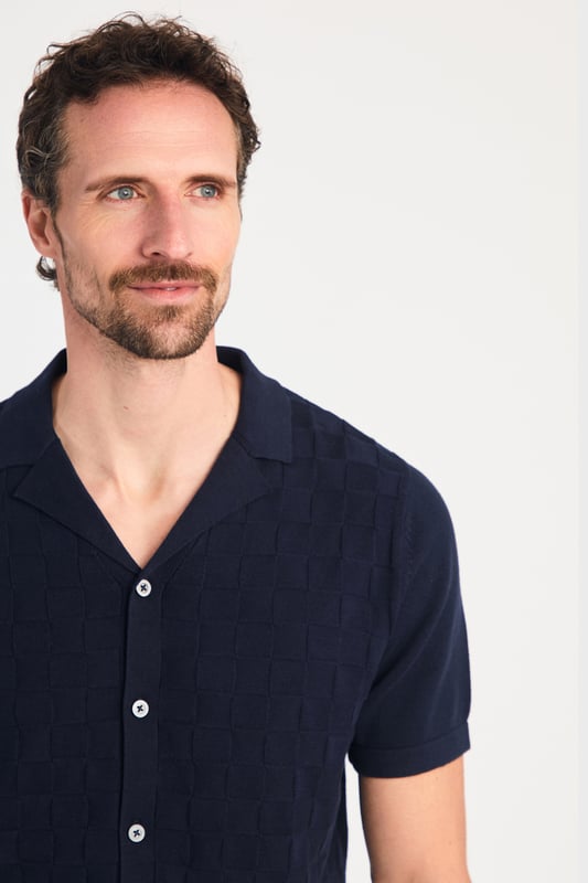 This knitted shirt from Kensington Eastside is a perfect mix of style and comfort. With a subtle checked pattern on the front and a laid-back Cuban collar, it’s an easy go-to for smart-casual outfits. Lightweight and breathable, it’s great for any occasion where you want to look sharp with minimal effort.