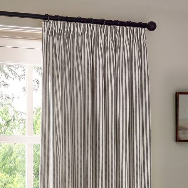 Transform your living space into a sanctuary with Hebden Striped Pencil Pleat Curtains. Crafted from 100% cotton, these curtains offer a soft, yet durable touch. The timeless, textured stripe design complements any minimalist or classic décor, while the room-darkening lining provides the perfect retreat from the outside world. Perfect for those who value natural materials, Hebden curtains are an investment in comfort and style, enriching your home environment without compromise.