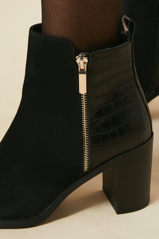 Mixed material design featuring faux leather and textile elements
        Side zip closure for easy on-and-off
        Block heel measuring between 7 and 9cm for comfortable elevation
        Ankle-high silhouette for versatile styling
        Sleek almond toe shape for a modern aesthetic
    
    Step out in style with the Melrose Mixed Material Side Zip Block High Heel Ankle Boot from Dorothy Perkins. These versatile boots blend contemporary design with practical comfort, making them perfect for the fashion-forward woman who values both form and function. The mixed material upper adds textural interest, while the side zip ensures effortless wear. Style these boots with opaque tights and a flowy midi dress for a chic brunch look, or pair them with skinny jeans and an oversized jumper for casual family gatherings. The block heel provides stability and comfort for all-day wear, whether you're running errands or meeting friends for coffee. These ankle boots are a wardrobe essential that will carry you through various daytime occasions with ease and sophistication.