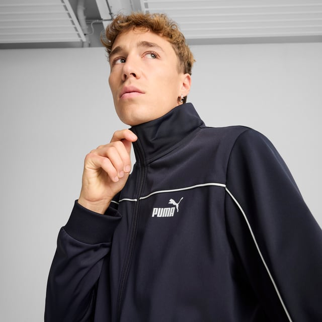 PRODUCT STORY: These everyday essentials feature a high-collar jacket with rib cuffs and waistband, plus pants with an elastic waistband and internal drawcord for customized comfort. PUMA No. 1 Logo rubber prints and piping details complete the look. FEATURES & BENEFITS: Made with at least 90% recycled materials. DETAILS: Regular fit; High-collar; Elastic waistband with internal drawcord; Ribbed cuffs; Closed bottom; PUMA branding details; 100% polyester Recycled - tricot - 220.00 g/m - piece dyed - Mechanical - Brushing, Mechanical - UPFMain Material 3: 100% polyester Recycled - tricot - 220.00 g/m - piece dyed - Mechanical - Brushing, Mechanical - UPF.  Our model is 180 cm tall and is wearing size M UK.