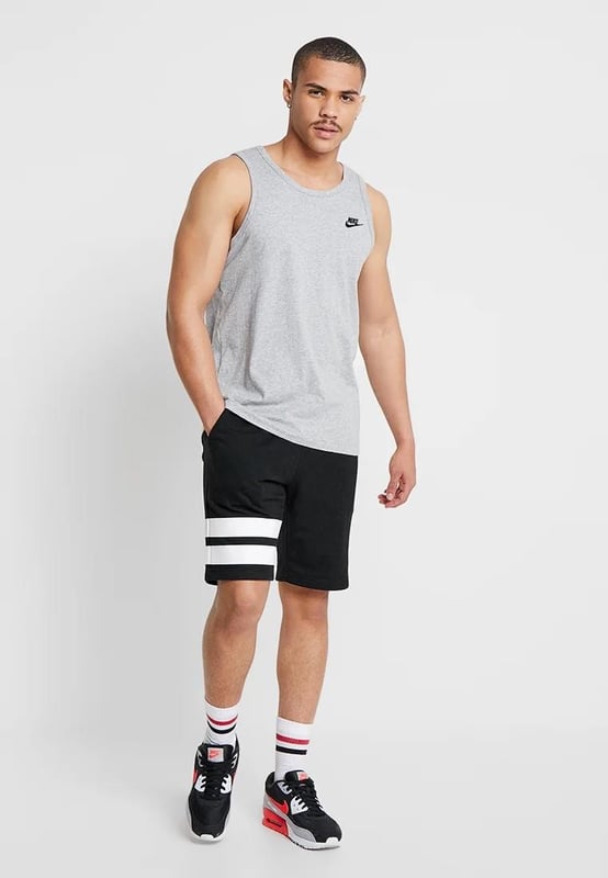 Nike practical and stylish tank top. The model will be perfect for both typical urban and sports sets. Thanks to the cotton fabric, it will allow the skin to breathe, ensuring constant comfort. The Grey colors have been broken with the Black Nike logo.
